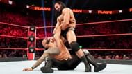 Ricochet trapped in an armbar applied by Drew McIntyre